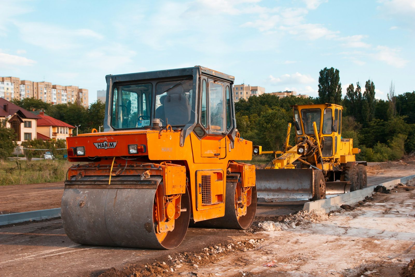 Road roller and grader on a road construction site